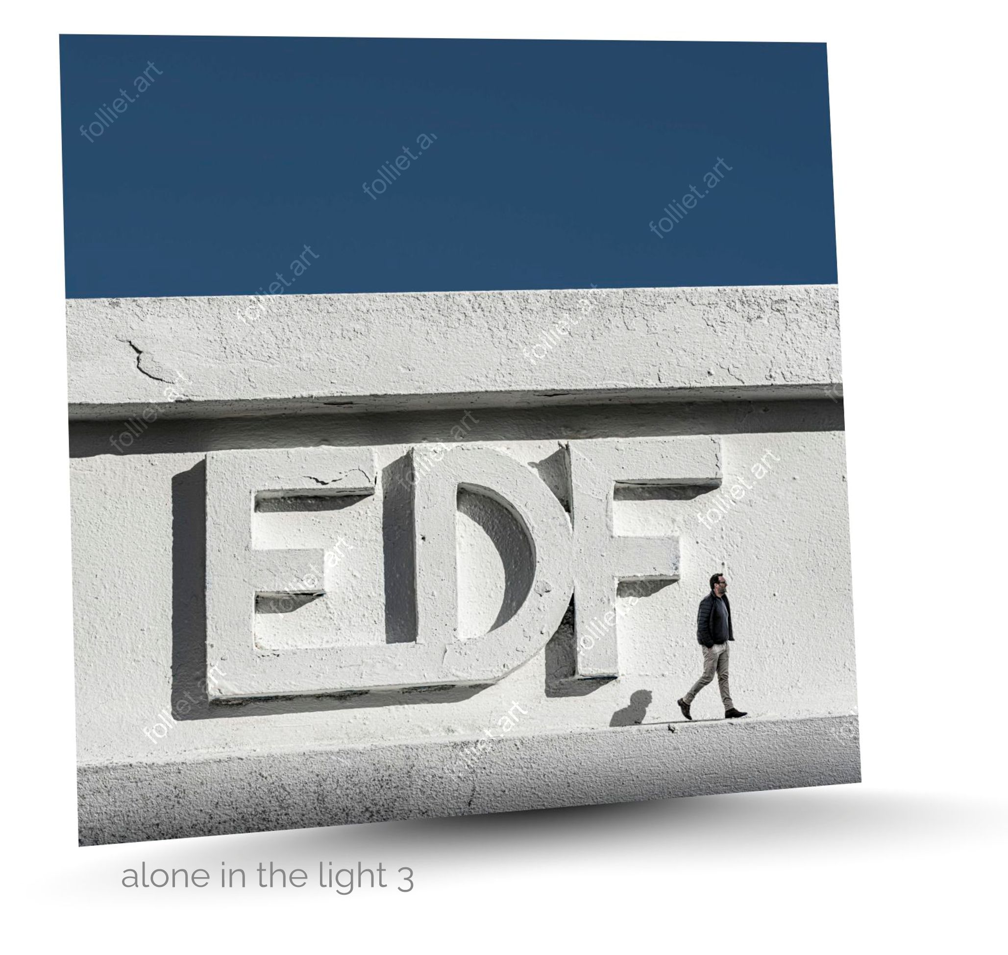 Modern architecture with embossed EDF lettering and moving pedestrian - fine art photography by Folliet