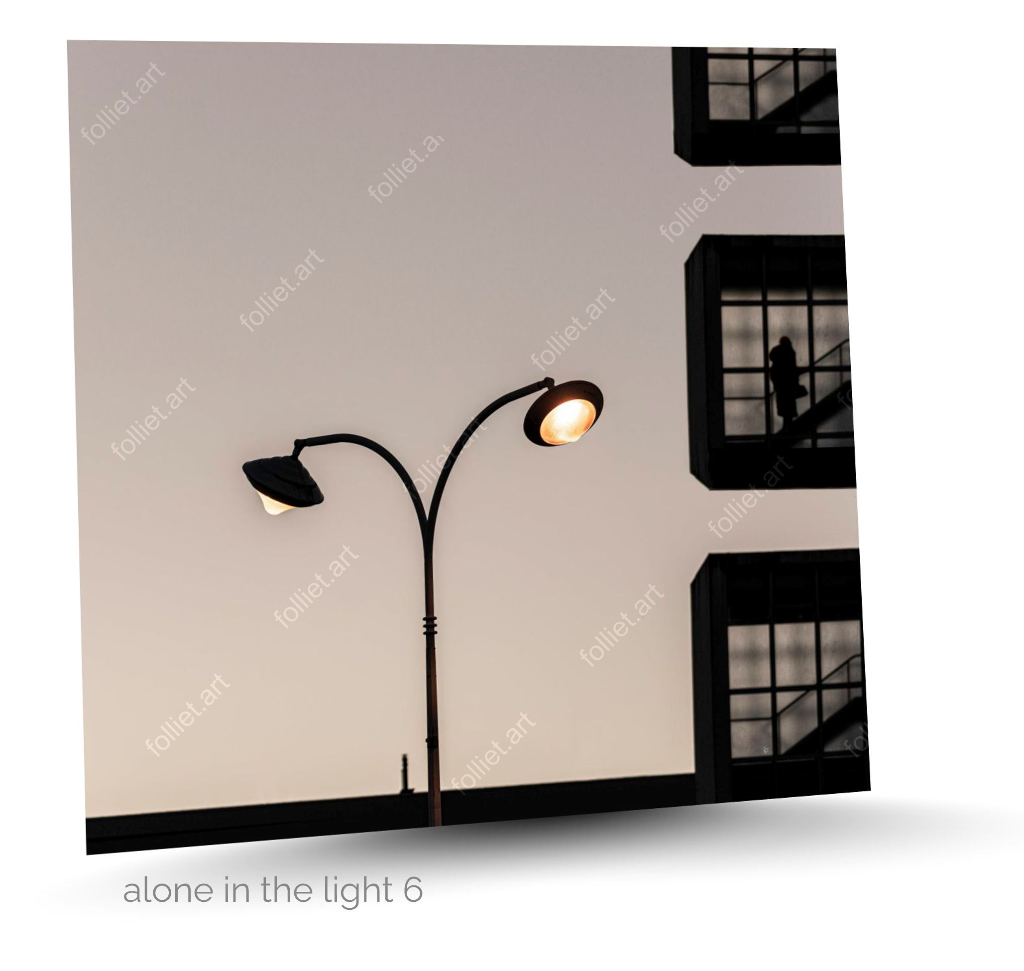 Floor Lamp and Contemporary Building in Which a Woman Climbs Stairs - Fine Art Photography by Folliet