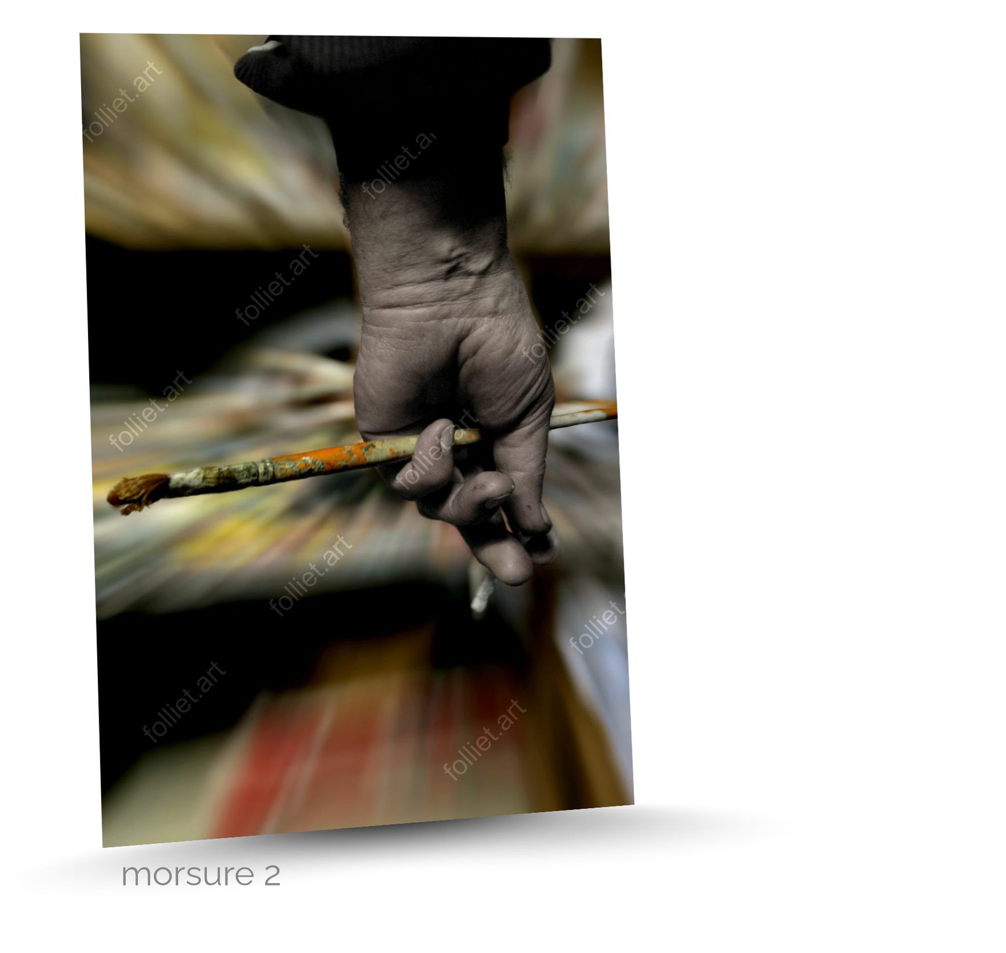 Artist's hand holding a brush on abstract background in motion - fine art photography by Folliet